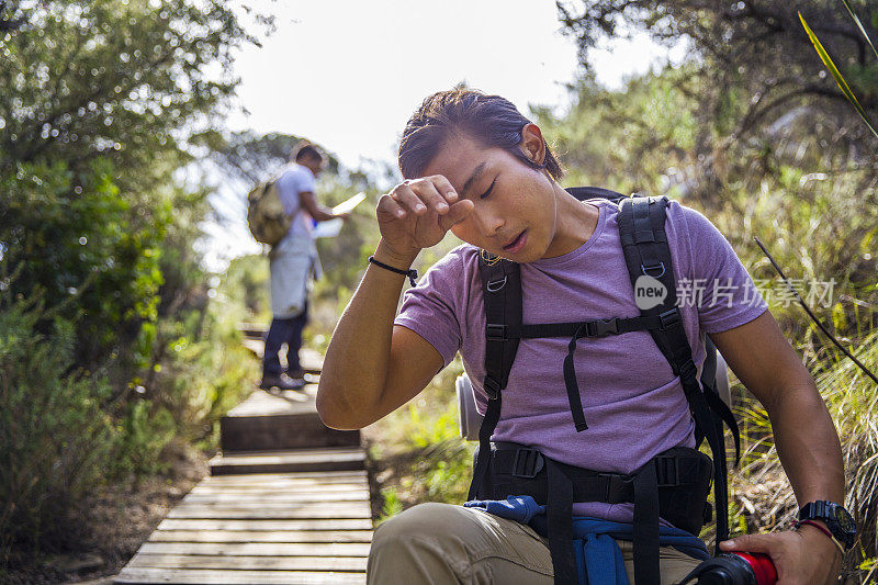 男性徒步旅行者擦拭额头上的汗水