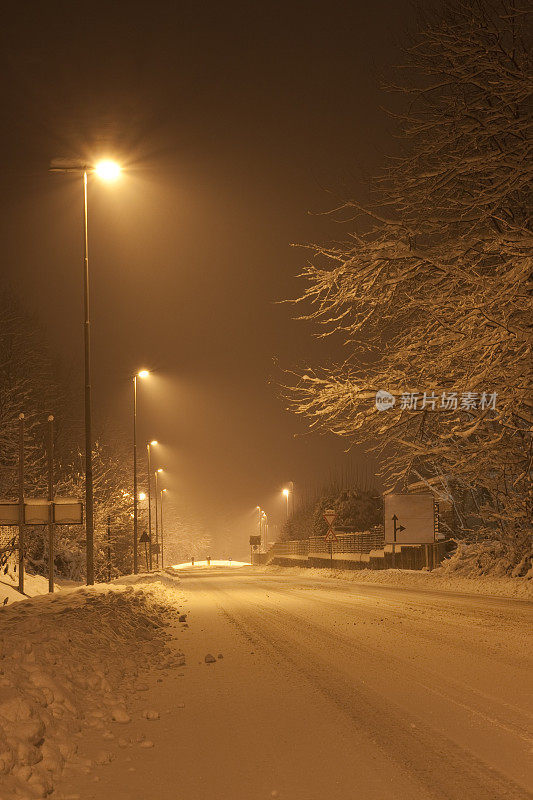 白雪覆盖的城市街道，夜景和深褐色调