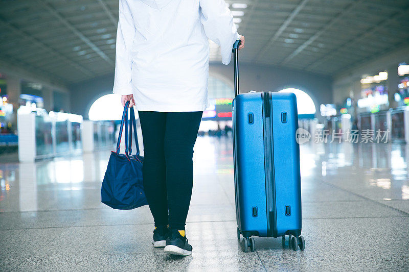 带着行李箱在机场的旅客