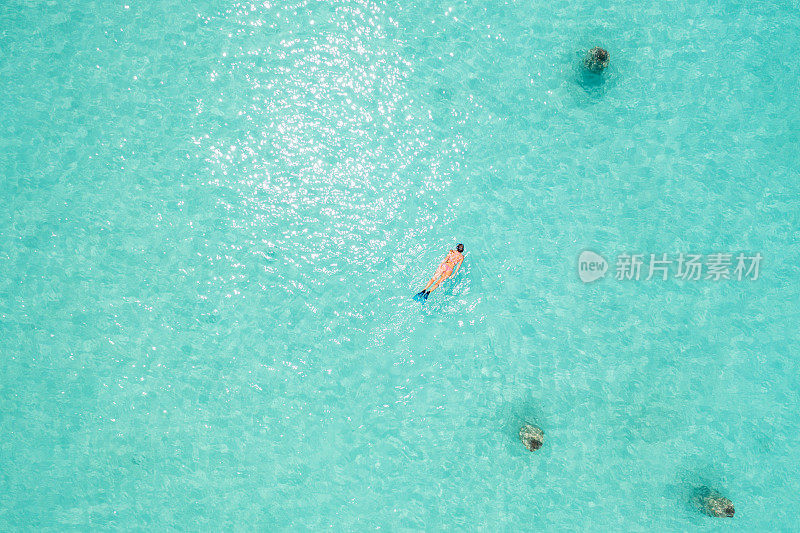 一名女子在马尔代夫潜水的无人机照片