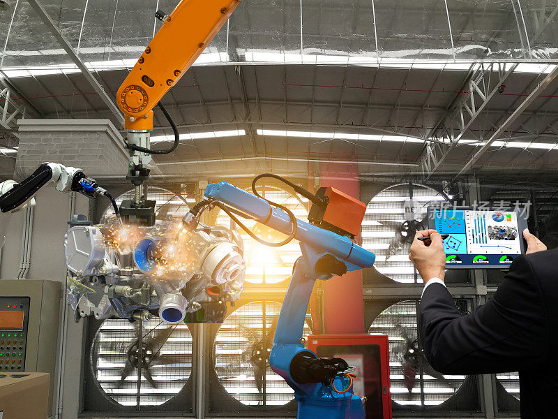 商人触摸屏控制机器人生产的工厂零件发动机制造工业机器人和机械手臂