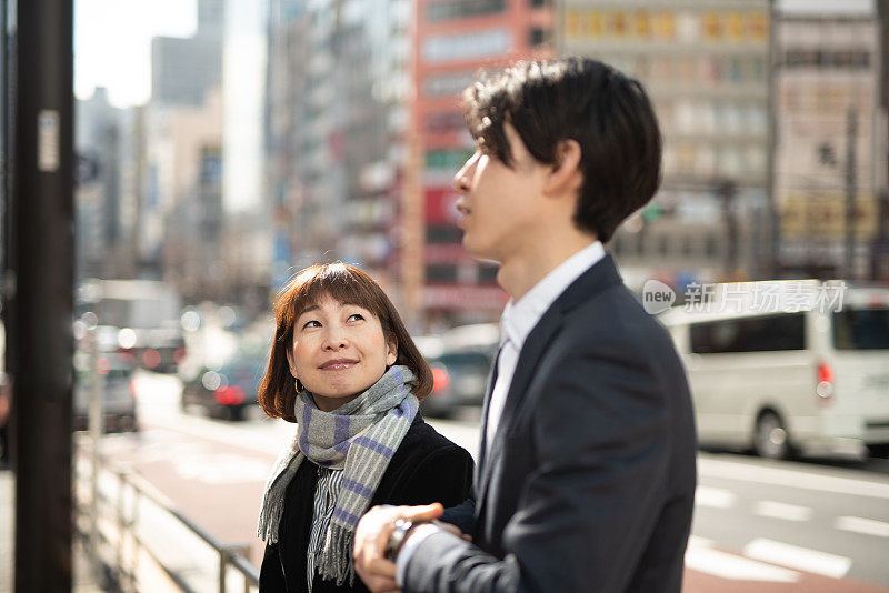 女经理和年轻商人在街上聊天