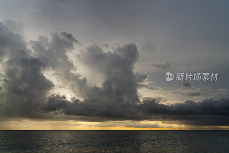 在斯里兰卡的希卡杜瓦，印度洋上空的壮观的天空和大量的雨云在风景优美的日落上。