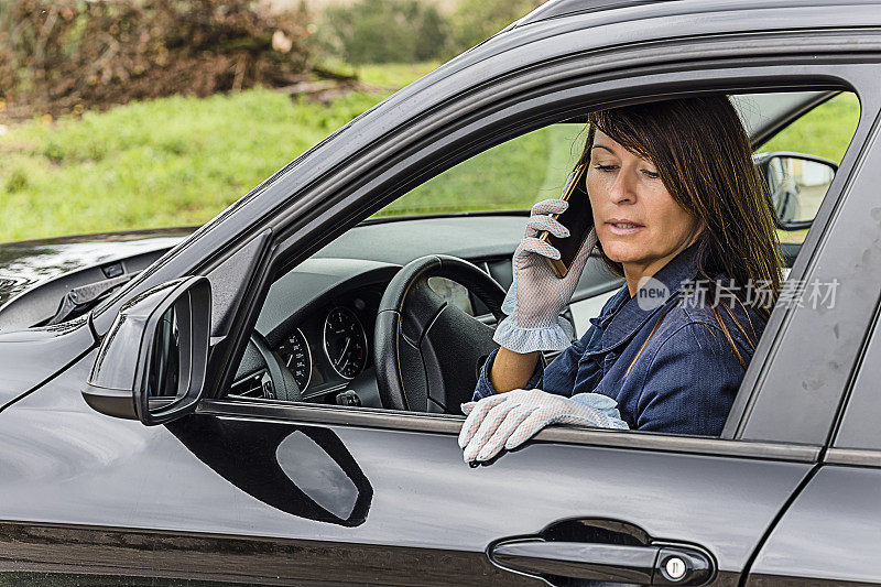 有电话的成熟女人一边开车一边打电话