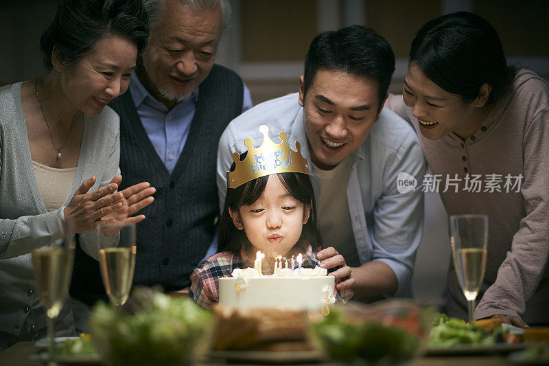 三代亚洲家庭在家里庆祝小女孩的生日