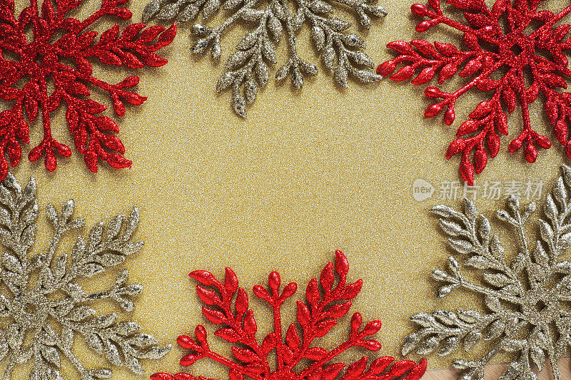 六个大的银色和红色的扁平华丽的雪花被放置在天鹅绒般的金色纸上。文本的自由空间。新年或圣诞节背景广告。喜庆的冬夜。黄红灰