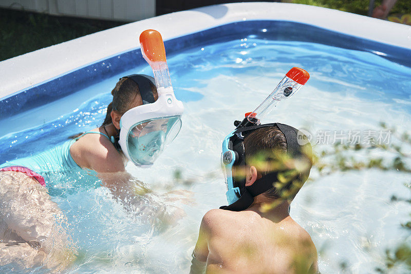 后院水有趣可爱的小孩在游泳池里玩浮潜谷歌