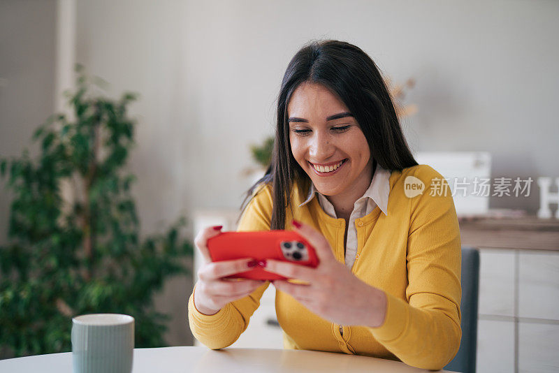 年轻女子正在用手机玩电子游戏。