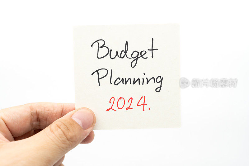 2024年预算规划短信用手写在纸上备注。预算计划概念。