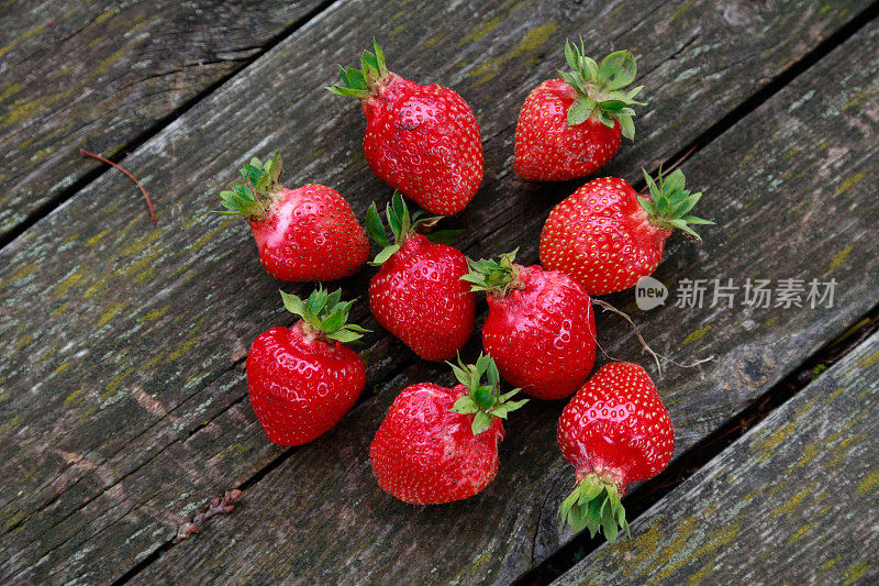 木桌上放着成熟的草莓