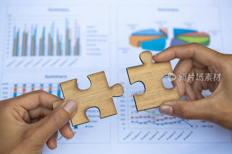 商人的两只手连接着一对拼图。联想和联系的象征。商业策略。