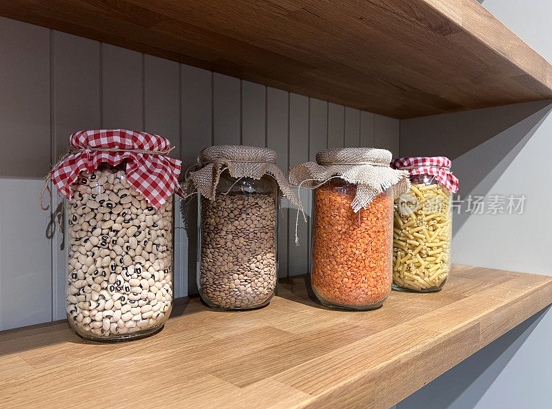 在厨房食品储藏室的罐子里装着豆类