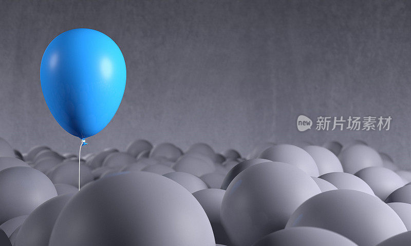 蓝色气球从灰色背景中升起:个性，突出