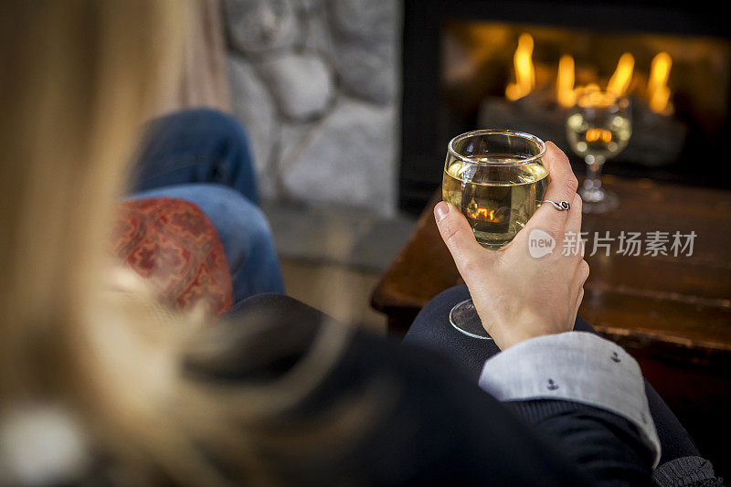 在屋里火炉边喝酒的女人。