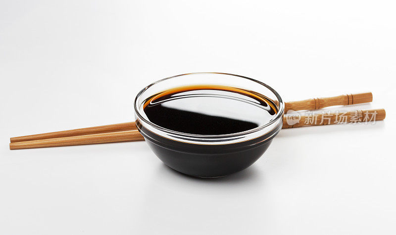 酱油和筷子孤立在白色的背景