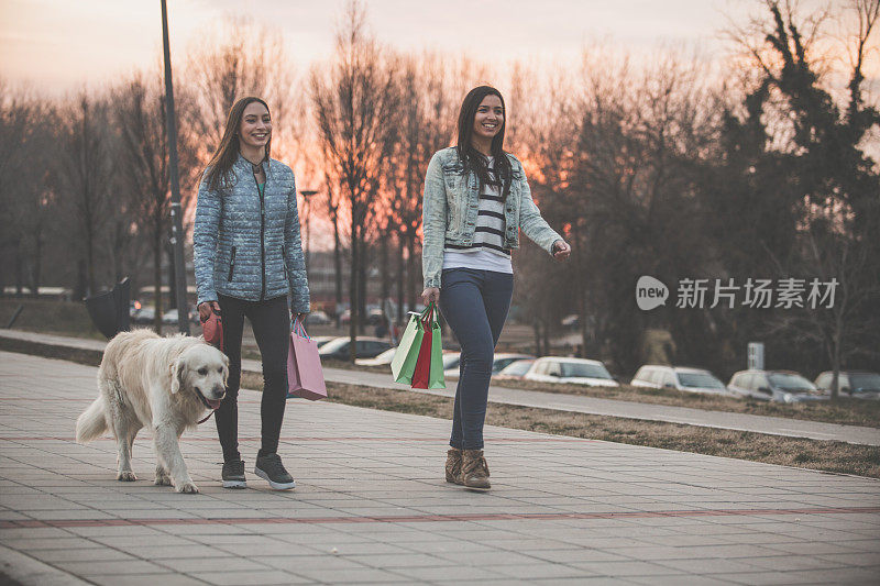 日落时分遛狗的快乐女人