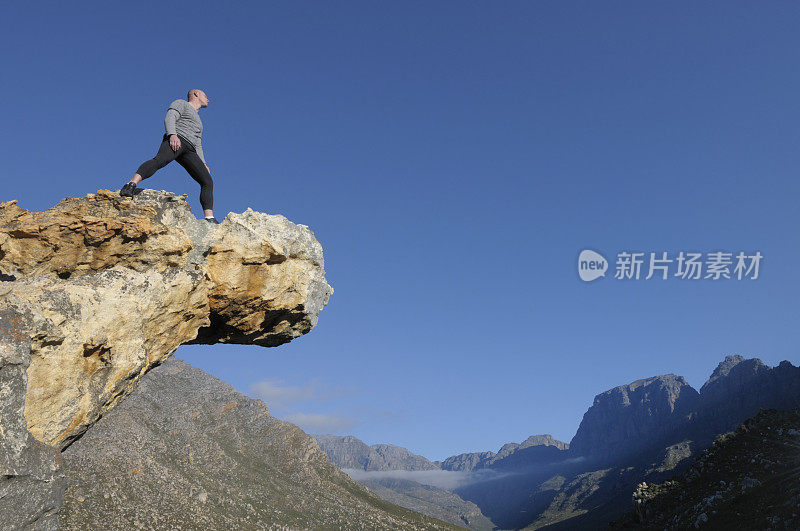 秃顶运动员横在岩石上