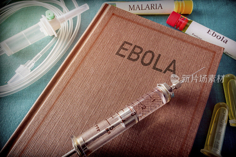 一本关于埃博拉的书上的老式注射器，医学概念