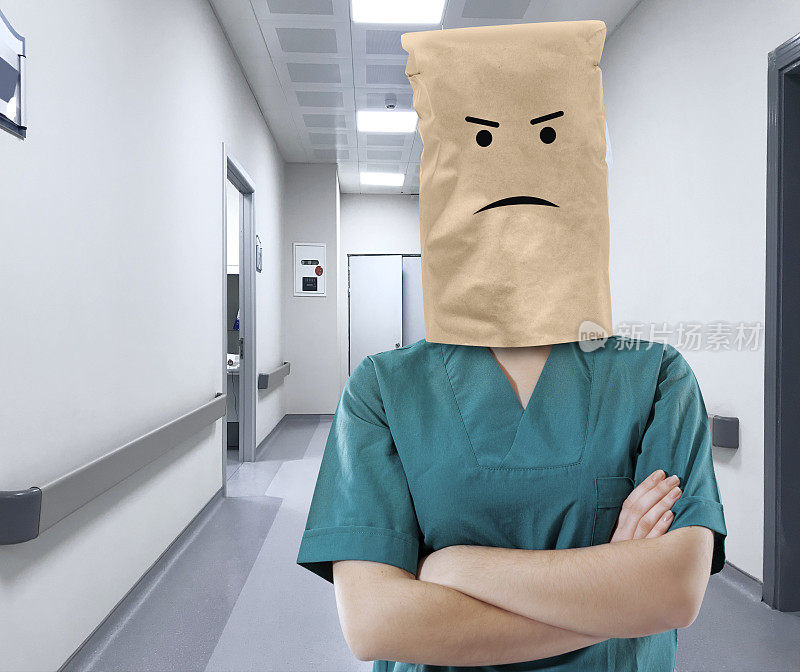 沮丧的医疗工作者用纸袋盖住她的头