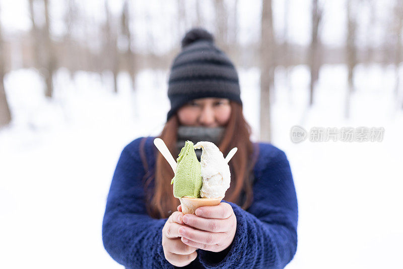 一位日本妇女在冬天吃抹茶冰淇淋