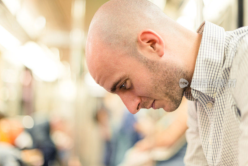 沉思的秃头男人在地铁上