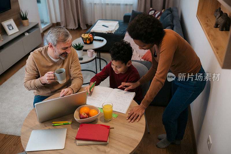 不同的家庭帮助他们的儿子做家庭作业