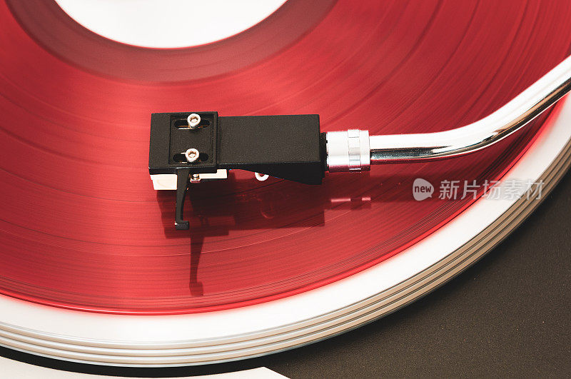 一个播放红色唱片的转盘的特写。