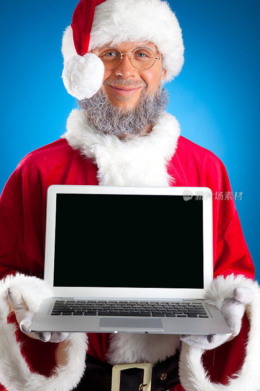 圣诞老人拿着笔记本电脑