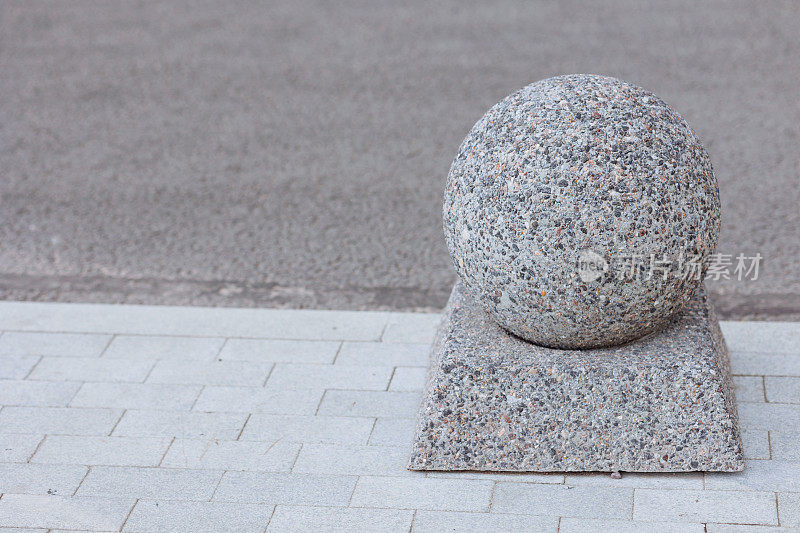 抛光花岗岩球体和底座在人行道上