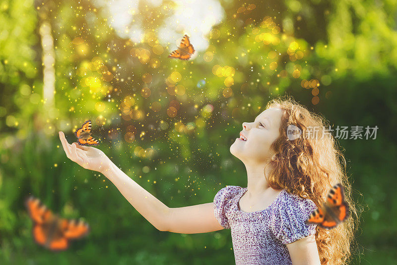笑着的可爱的孩子，手上有一只蝴蝶。