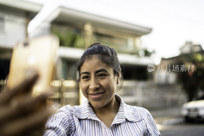 一个拉丁女人在城市街道上自拍