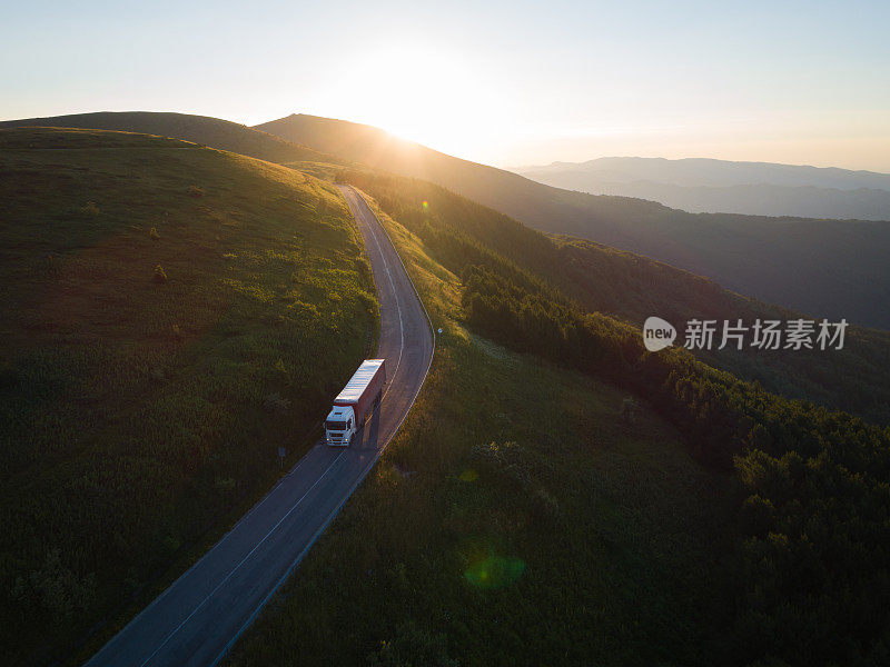 日落时分，快递公司在山间的森林道路上行驶。