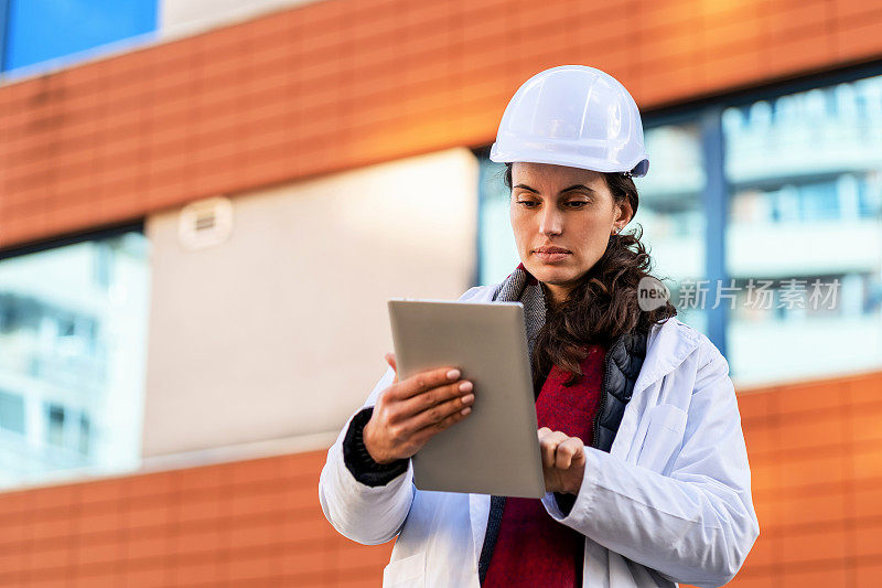 女性建筑工程师在工作场所使用平板电脑