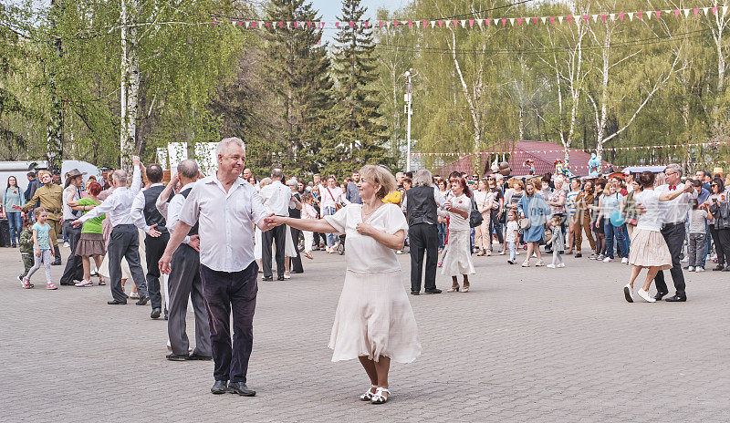老年情侣在公园跳舞。