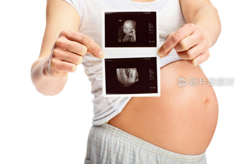 拿着超声波扫描仪的孕妇腹部