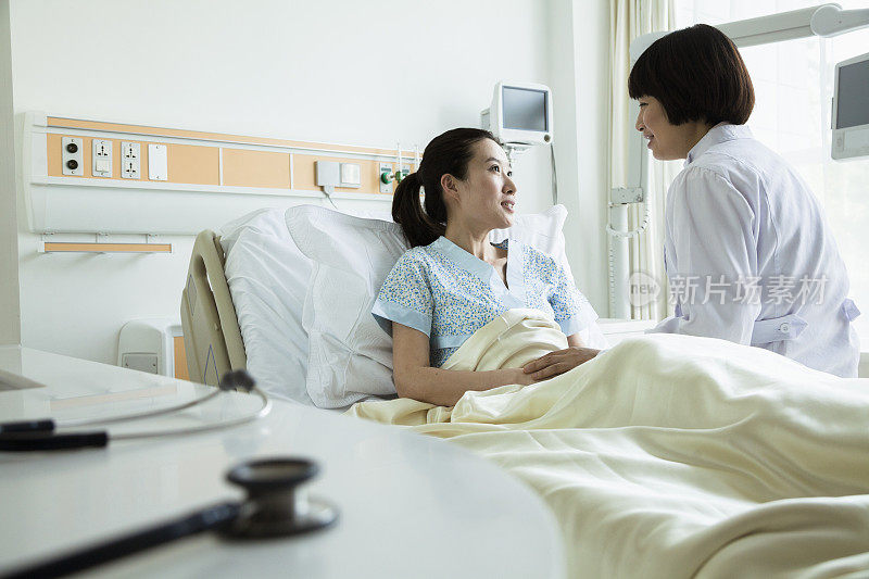女亚洲医生与年轻的亚洲女性病人交谈