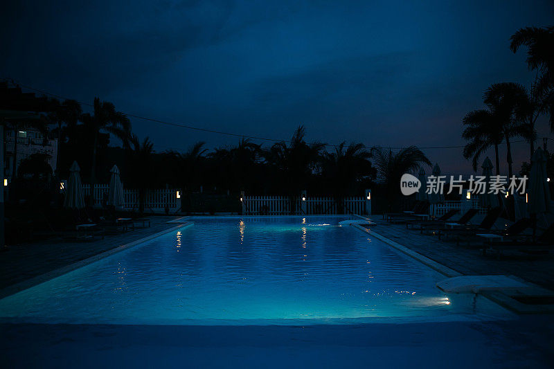 游泳池在夜间照明热带岛屿