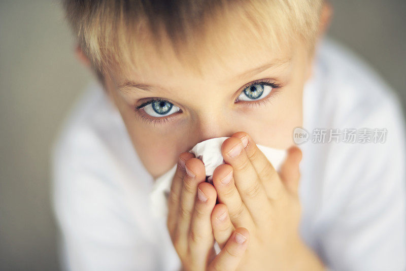 一个生病的小男孩清洗流鼻涕的特写镜头。