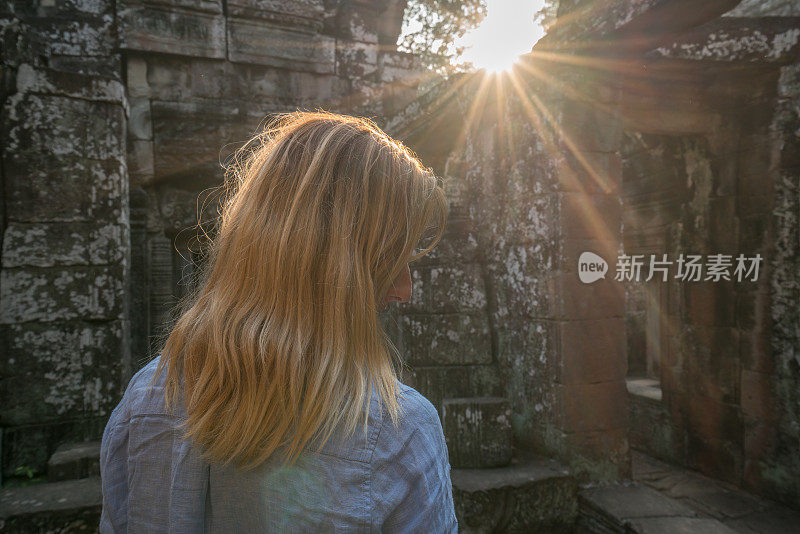 女游客漫游在古老的寺庙日落享受发现和旅游在亚洲，柬埔寨吴哥窟