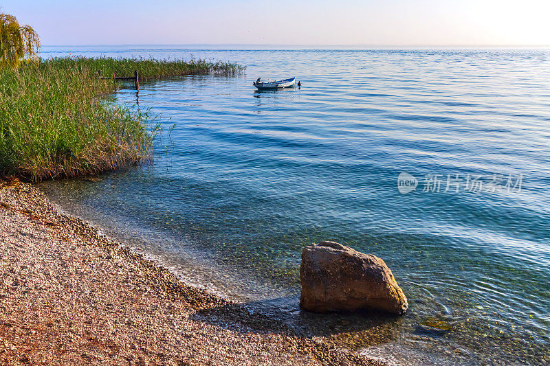 加尔达湖和平静水面上漂浮的小船
