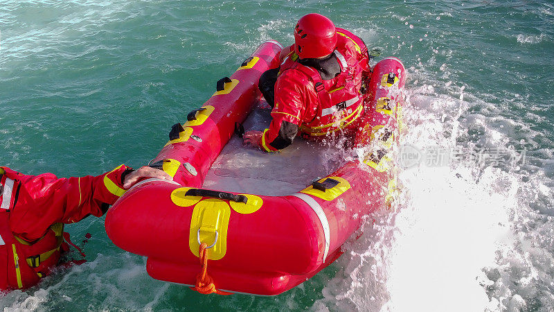 消防队员在水上救援演习中，使用独木舟和特殊的制服。