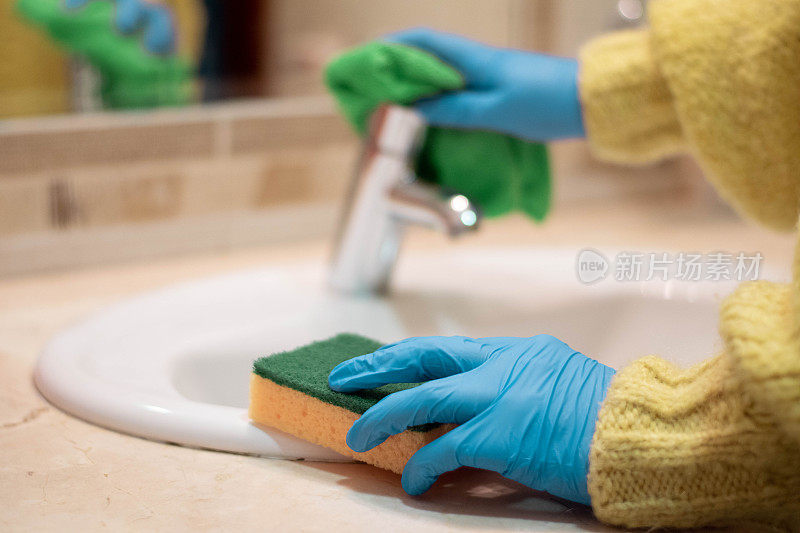 用喷雾清洁剂、橡胶手套和洗碗布清洗