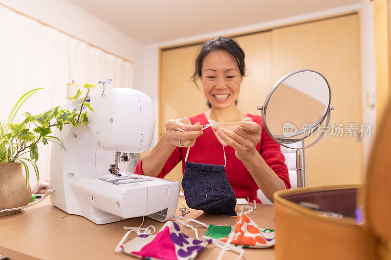 一名日本妇女在家里制作面具