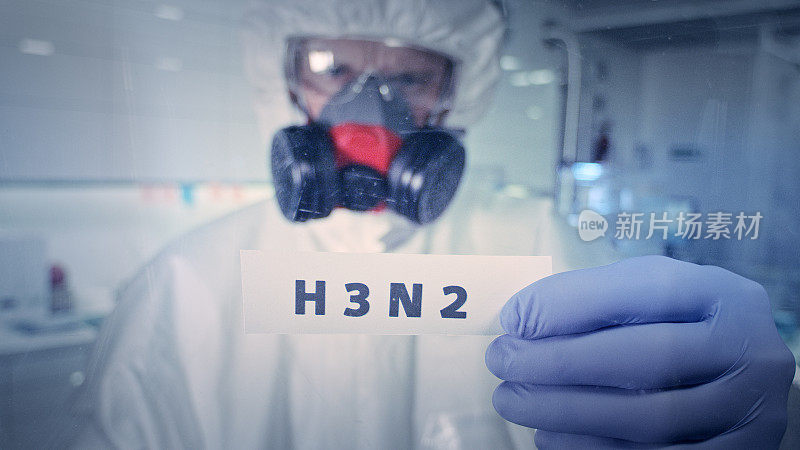 单词“H3N2”在实验室着火。带防毒面具的医护人员