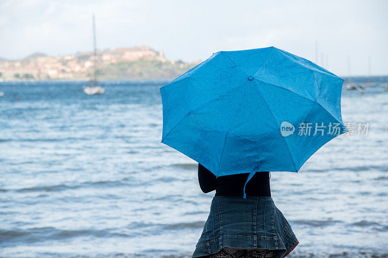 旅行。在一个雨天的海边。