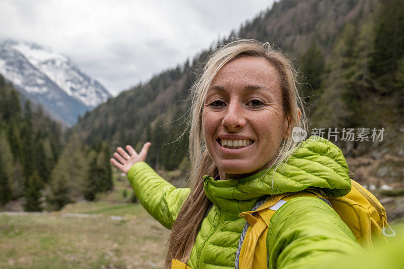 在山里徒步旅行的年轻女子在自拍