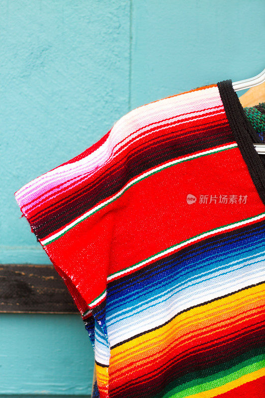 传统充满活力的墨西哥条纹羊毛雨披;青绿色的背景