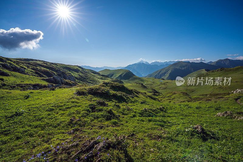 高加索山脉上美丽的风景。明亮的日冕在图像的左上角