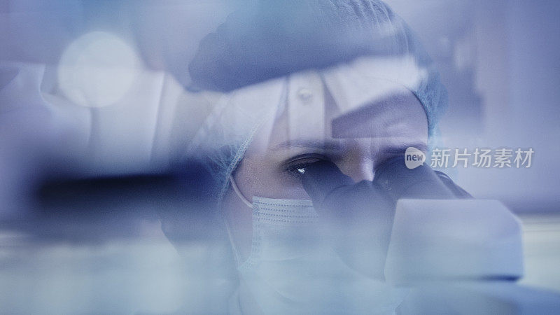 与有害生物物质打交道。女人使用显微镜。透过玻璃器皿