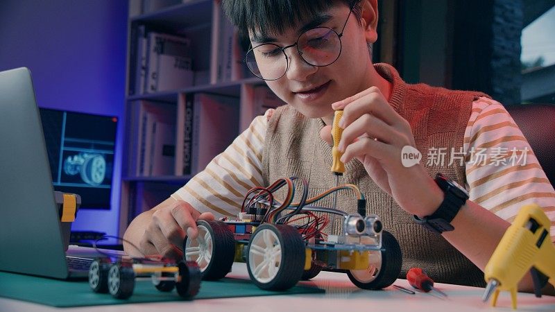 亚洲青少年在做Arduino机器人家庭作业